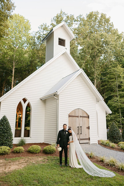 Bride and groom outside white chapel at Nashville wedding ceremony