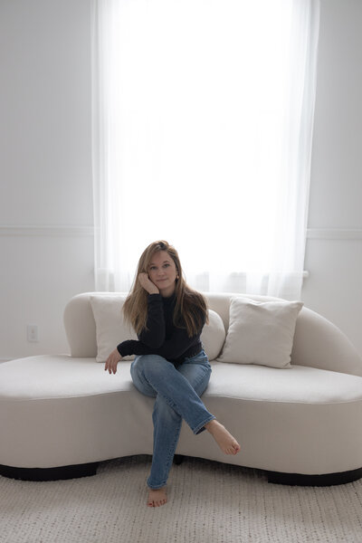 Martina Biljan sitting on couch creative brand strategy