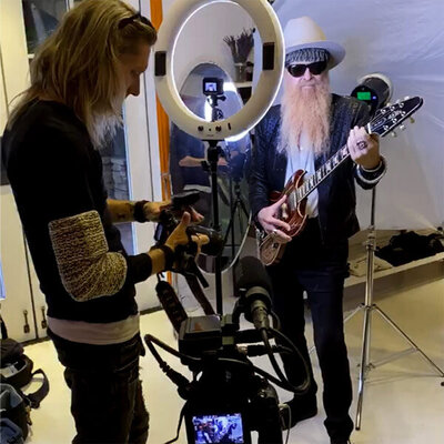 Billy F Gibbons Behind the Scenes Photo The Art of Giving Billy holding guitar whil Mark looks at camera back