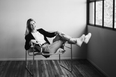 Woman looks at camera smiling while wearing a pink suit jacket - Brisbane family photographer