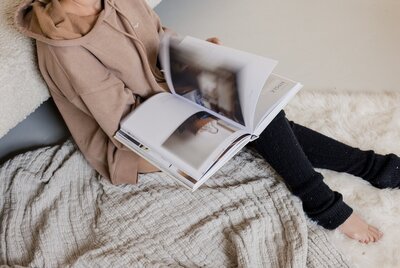 Journal and pen on blanket on chair with slippers beside