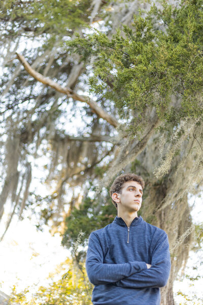 senior boy with tree with moss
