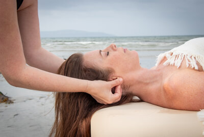 Massage therapist gives a head massage to calm mind in galway