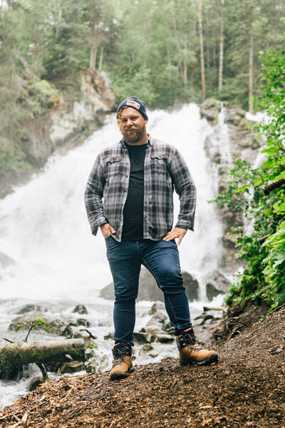 elopement photographer in alaska in front of waterfall