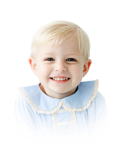 Child sitting in heirloom outfit for heirloom photography session