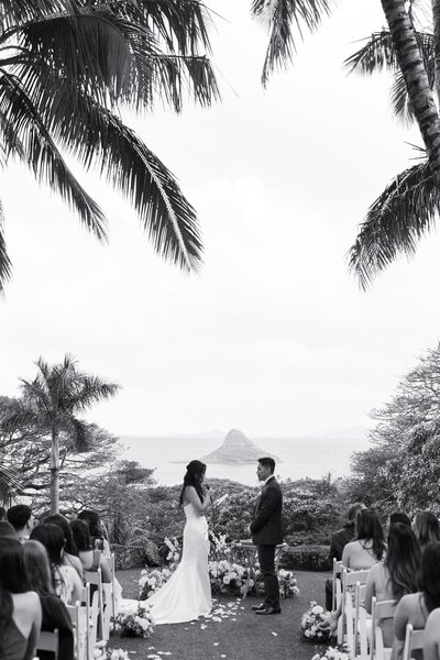 A person holding a mic and saying their vows to their partner 