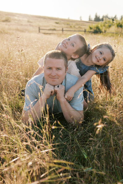 Father and two kids playing in the field