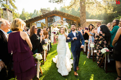 Bride and Groom strut down the aisle after a mountain top wedding