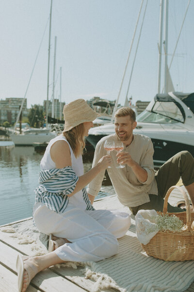couple having drinks on a dock in Granville Island