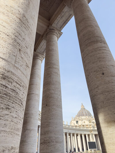 View of St. Peter's Basilica through the arms of St. Mark's Square in Vatican City.