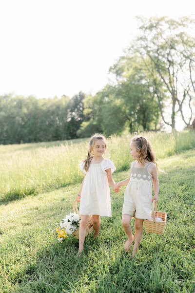Family of four runs into sunset on the sand