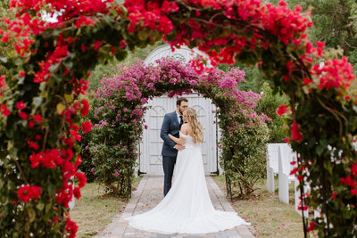 bride and groom holding each other and smiling