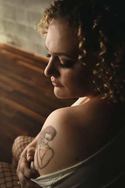 Plus size woman in pink leaning on window