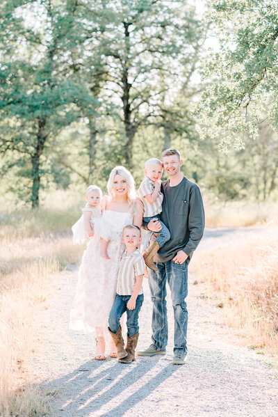 Redding CA Portrait Studio captures families outdoors. This image of a family of 5 is beautifully backlit.