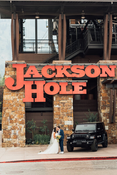 couple kissing under Jackson Hole sign