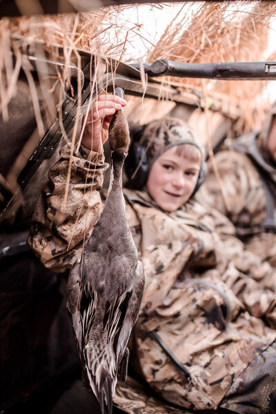 Young duck hunter showing off is pintail
