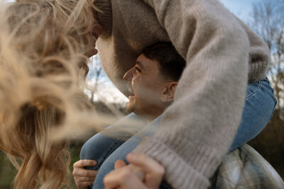Engaged couple spins as girl looks down to guy during golden hour at Harlinsdale Farm in Franklin, TN.