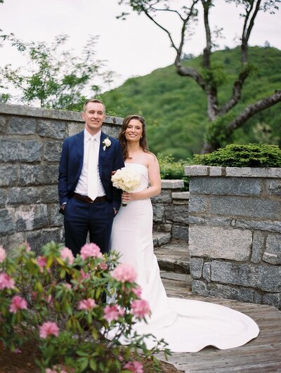 A bride and groom smile at the camera for an asheville wedding photographer