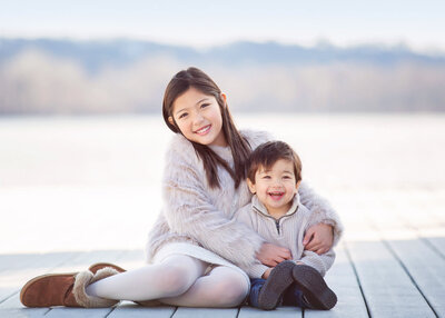 brother and sister laughing in family session with Los Angeles newborn photographer