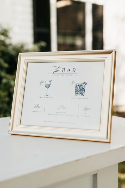 Gold framed signature drink sign displayed on the bar at Ashford Acres Inn in Cynthiana, KY.