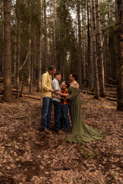 Family enjoying a photo session in a forest setting in Utah, captured by Lamblight Photography