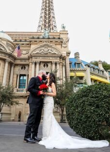 Yolanda & Adrian kissing in front of the eiffel tower in las vegas nevada