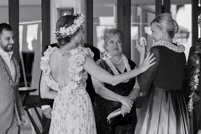 Wedding guests laughing and crying together 