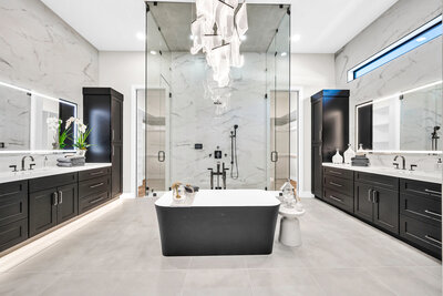 Marble backsplash by Vadara, glass shower, white cabinets
