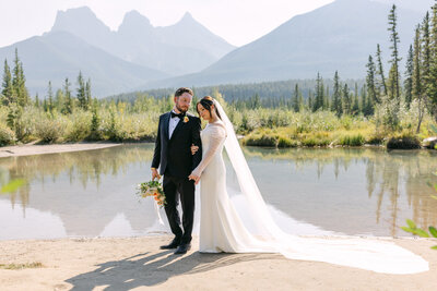 This stunning wedding day portrait captures the bride and groom with Mount Rundle, Tunnel Mountain, and the iconic Banff Springs Hotel as a backdrop. Set in Banff National Park, the breathtaking landscape perfectly complements the couple's love and joy on their special day.