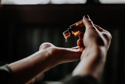 Skincare oil being poured into hand