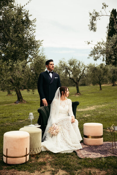 The bride and groom strike a pose during their wedding photoshoot, embodying timeless beauty against the enchanting backdrop of Lake Garda's nature