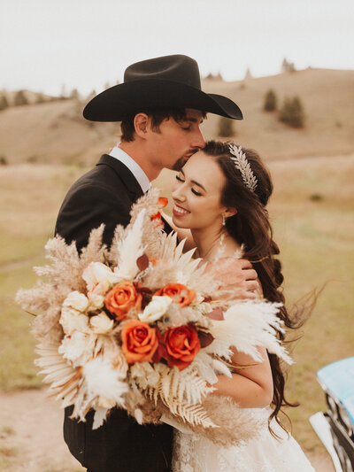 Aurelia smiling with her husband on their wedding day.