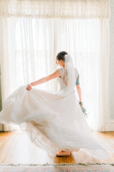 bride twirls her dress near Omaha