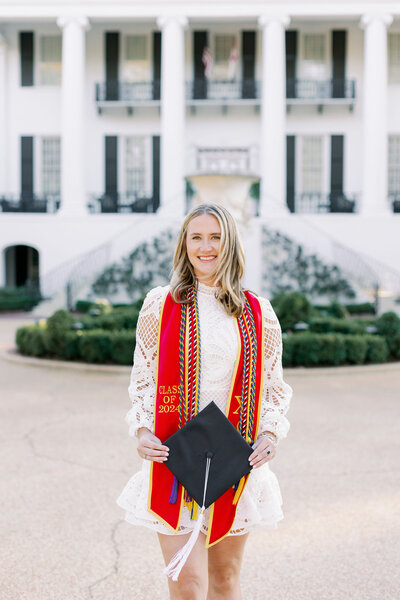 Graduate smiling with her cap and cords