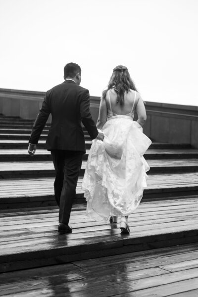 Bride and groom walking up steps, captured by Halifax wedding photographer, Samson Learn.