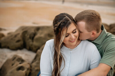 A couple cuddling during their engagement session in St. Augustine, FL