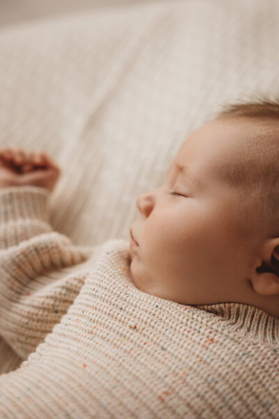 Wanaka newborn photography session by captured by bie of a baby laying on a pillow