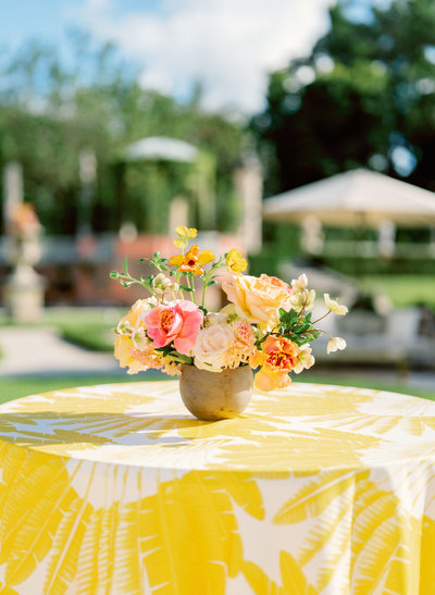 colorful floral arrangement on yellow table linen
