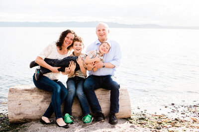 mom dad and kids pose for family portrait in west seattle