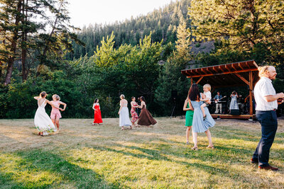 Live band wedding reception with guests dancing at Blackfoot River House in Bonner, MT
