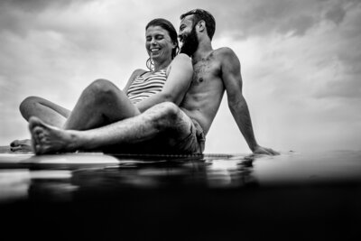 couple on a paddle board during their engagement session on Lake Champlain, Vermont