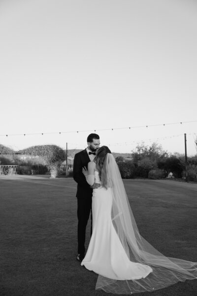 Bride and groom post together for a photo the night before their wedding at El Chorro in Paradise Valley, AZ during their rehearsal dinner at the venue. 