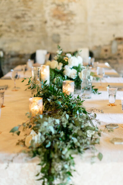A tablescape with candles and greenery