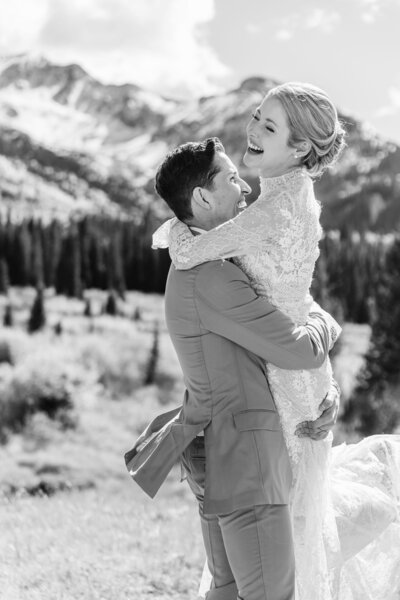 Married couple embracing in the snowy mountains of Colorad