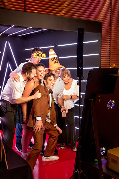 group of people at a wedding using a photo booth