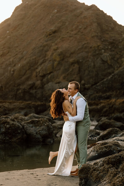 Couple embracing on a beach on the Oregon Coast.