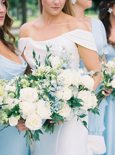 film portrait of bridesmaids bouquets with blue dresses and white and blue flowers in Fayetteville, Arkansas at Inn at Carnall Hall