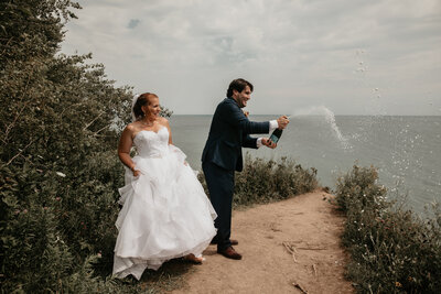 Bride and groom pop a bottle of champagne for San Antonio, TX wedding photographer