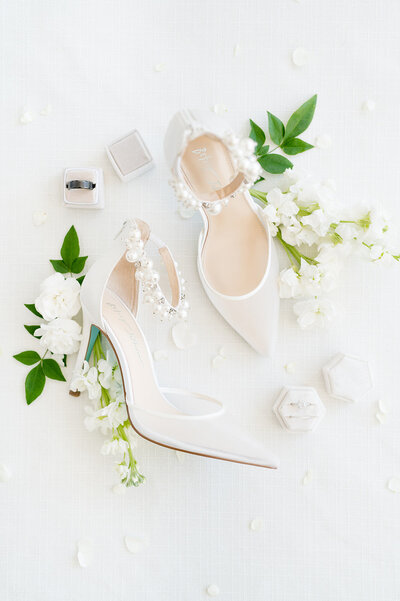 Bride's shoes lay with flowers.