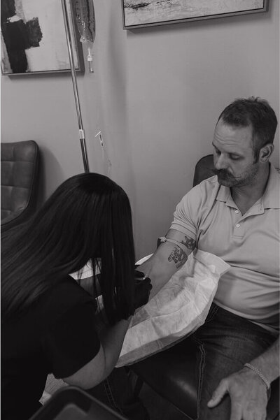 A nurse gently puts in an IV into her patients arm at the clinic in Idaho Falls, Idaho.